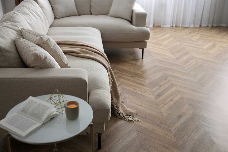 Person stepping barefoot onto a tile floor with visible sunlight casting warmth across the room.